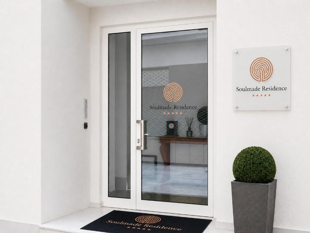 a glass door with a sign for a building at Soulmade Residence in Cosenza