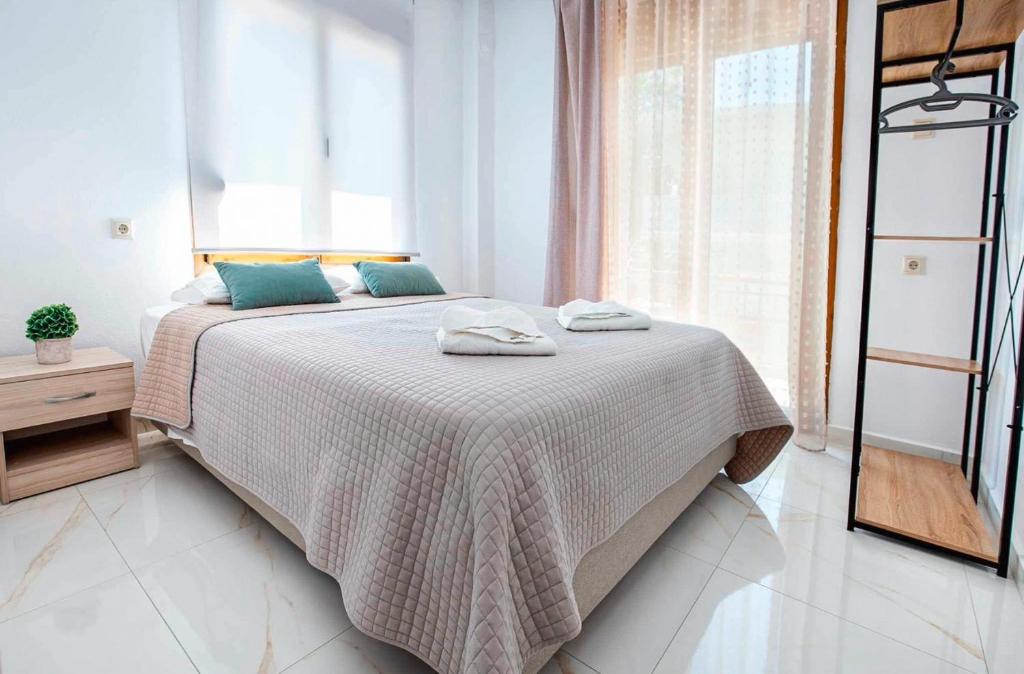 a bedroom with a bed with two towels on it at Lena Apartments 4 in Potos