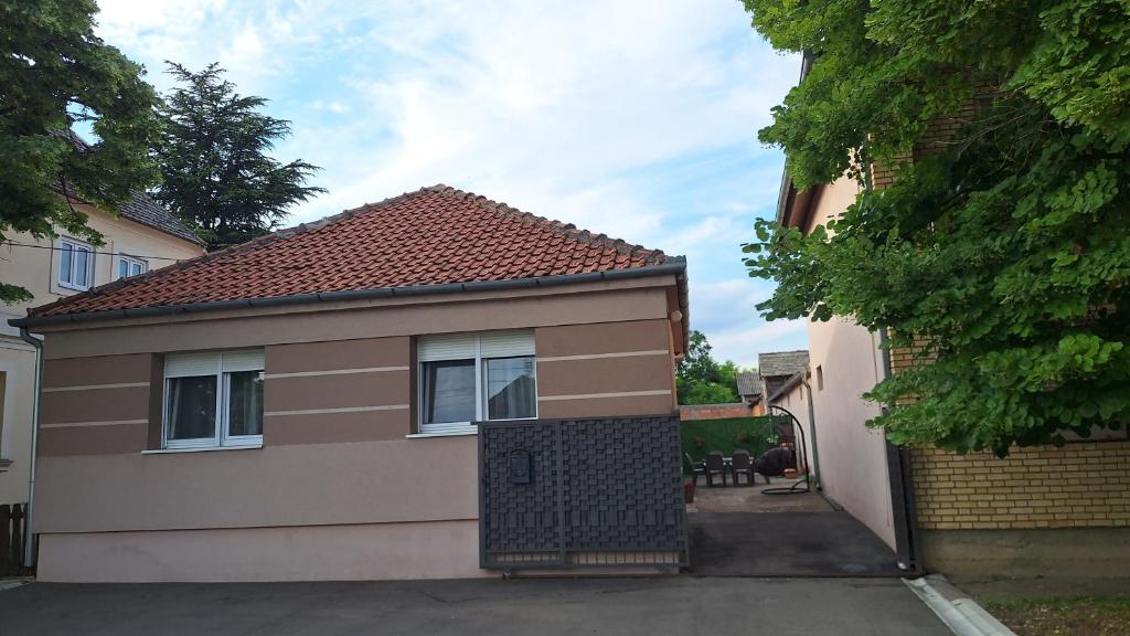 a small house with a garage in a driveway at Veslo IN in Krčedin