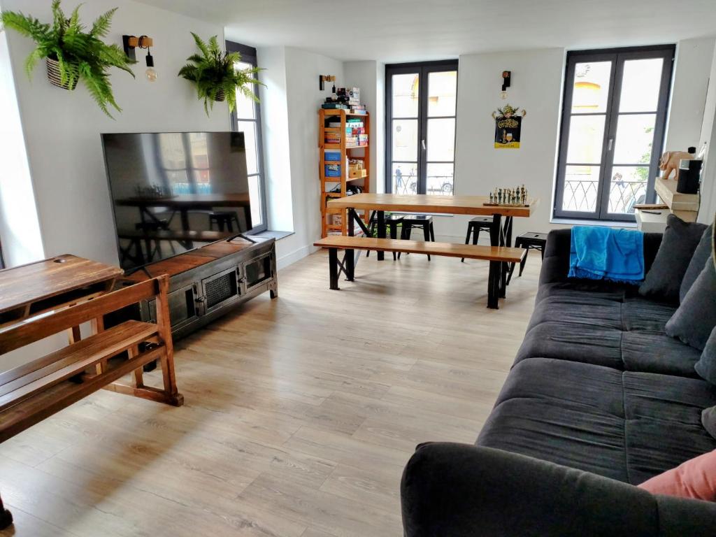 a living room with a couch and a table at Le Grand Stanislas in Nancy