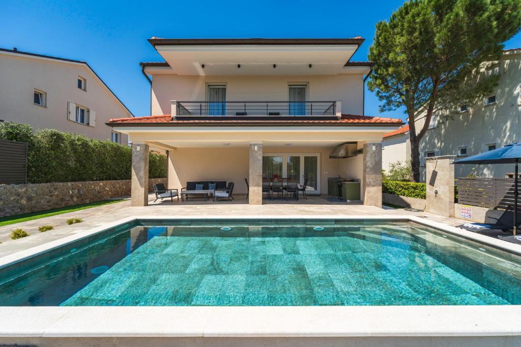 a villa with a swimming pool and a house at Villa Manuela in Porat