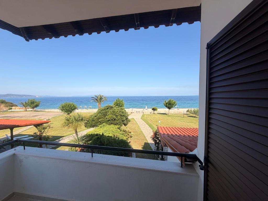 a view of the ocean from the balcony of a house at Villa Nikoleta - Beach Front luxury villa with beach access in Akti Salonikiou