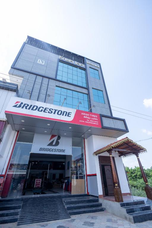 a building with a sign on the front of it at Krish Inn in Chidambaram
