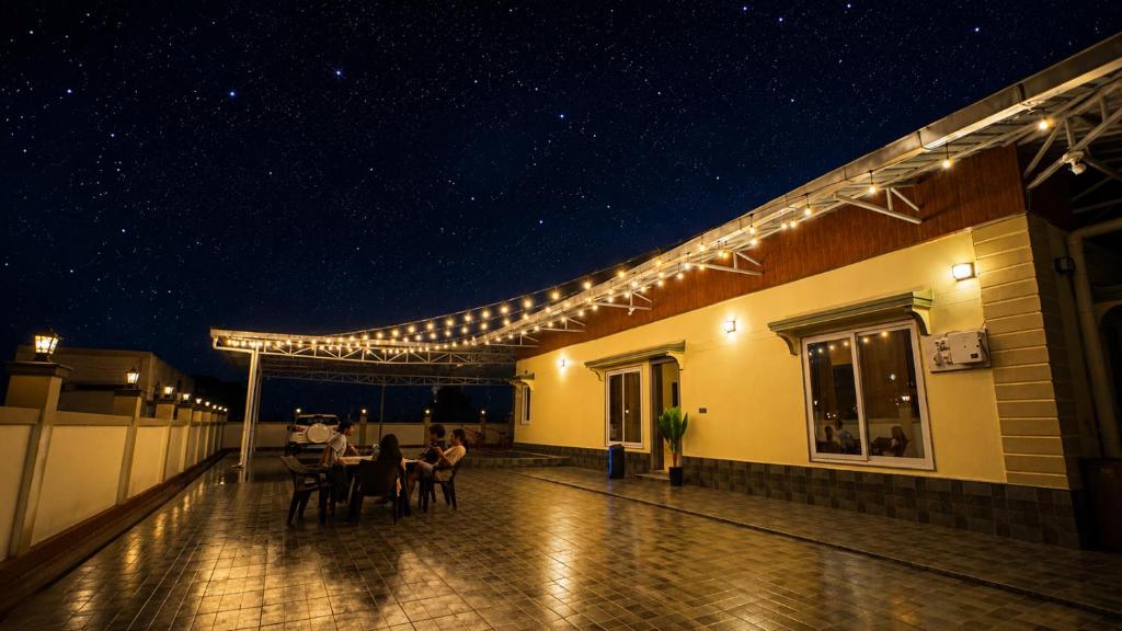 a patio with a table and chairs on a building at Jhigu in Siliguri