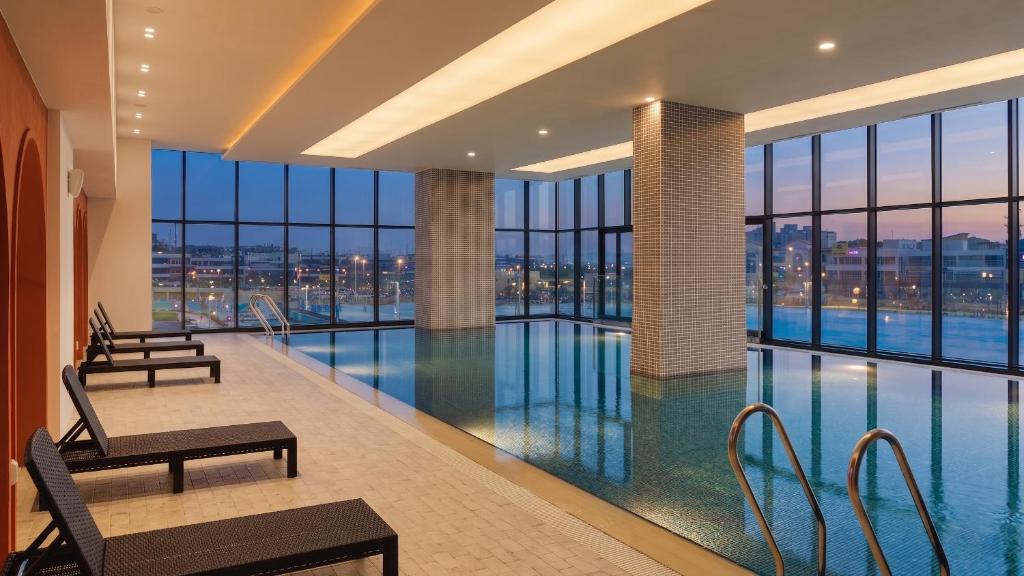 a swimming pool with a view of a building at Le collective Siheung Wavepark in Siheung