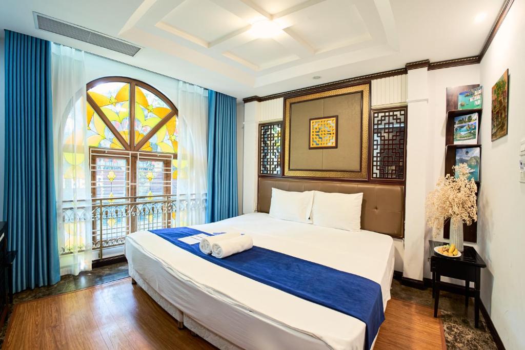 a bedroom with a large bed and a window at Ha Noi Capital Boutique Hotel in Hanoi