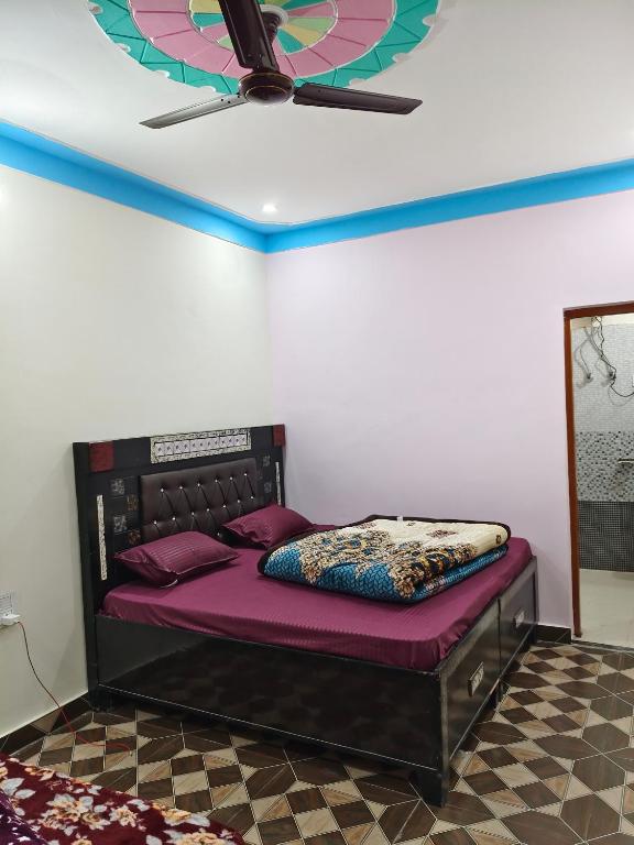 a bed in a room with a ceiling fan at Himalayan due lodge chopta in Sari