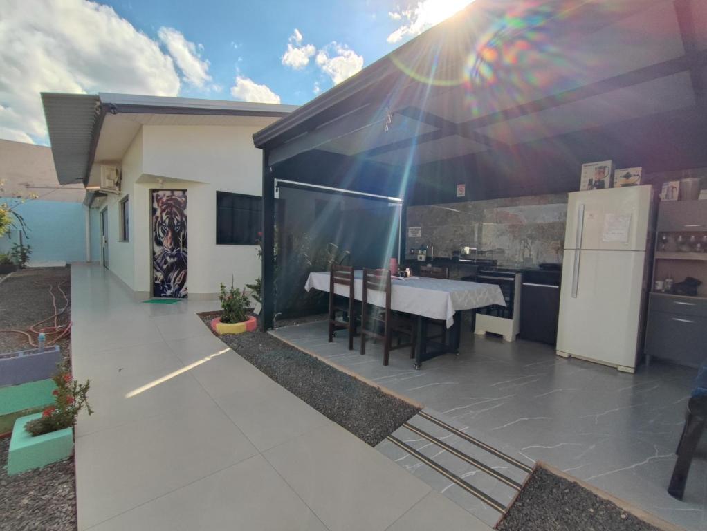 a kitchen and dining area of a house with a table at Quarto Califórnia in Campo Novo do Parecis