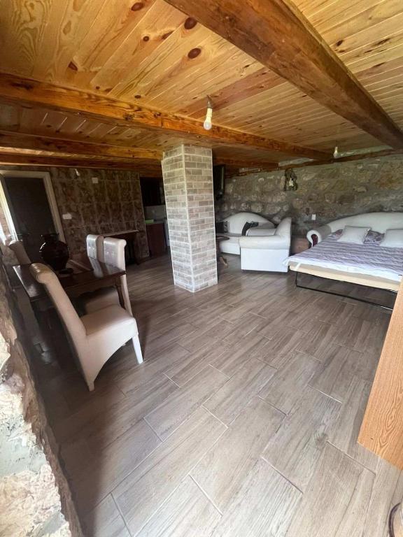 a living room with a bed and a fireplace at Konak Vrela Žabljak in Žabljak