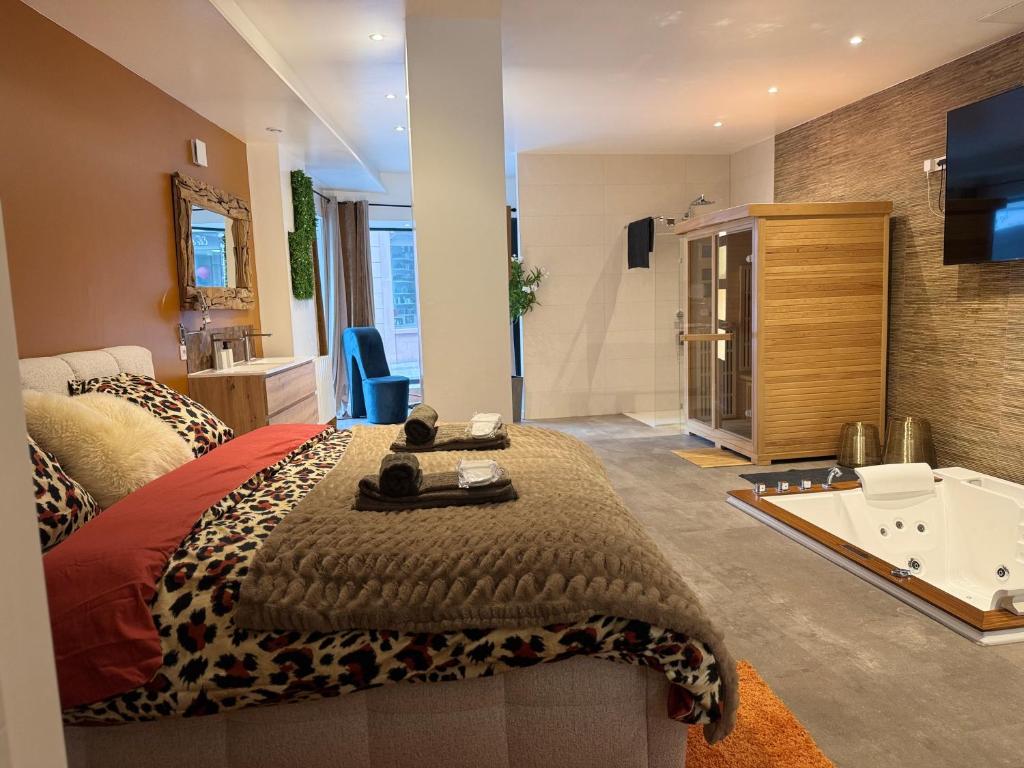 a bedroom with a bed and a bath tub at Les Nuits Douces in Bitche