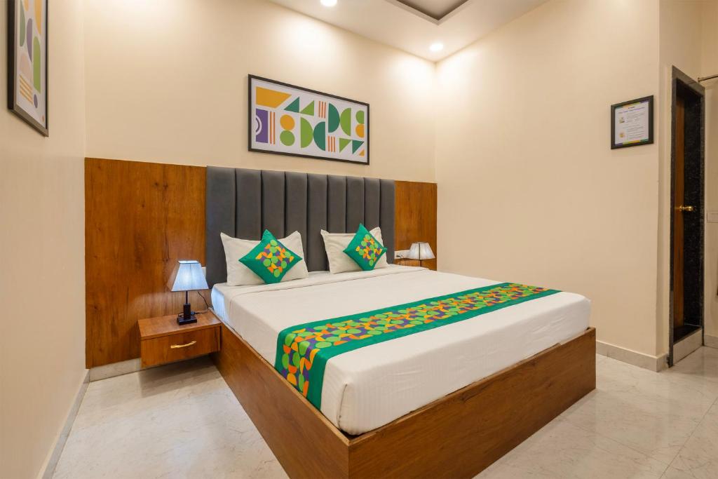a bedroom with a large bed in a room at Treebo Ayodhya Grand in Madnāpur