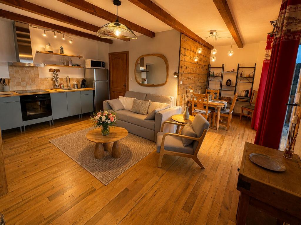 a living room with a couch and a table at Le Panorama in Soultzeren