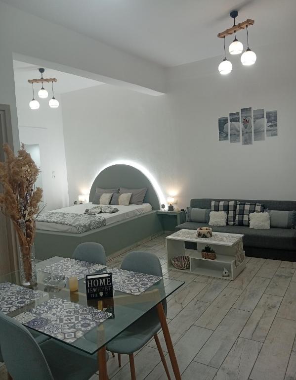 a living room with two beds and a table at Nikolas Aggelis rooms in Pera Gyalos