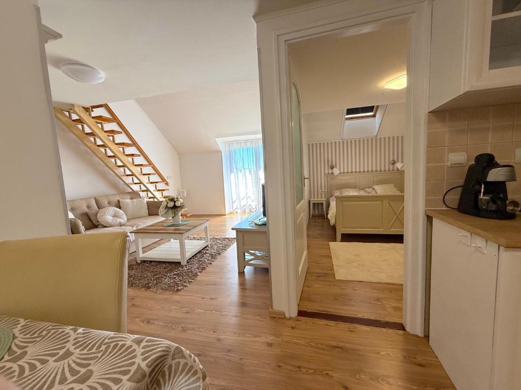 a living room with a couch and a table at Gyulai idill apartman in Gyula