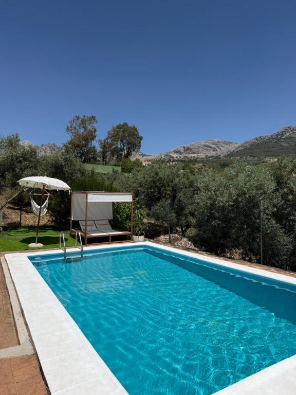 a swimming pool with a view of a mountain at Casa Manila in Colmenar