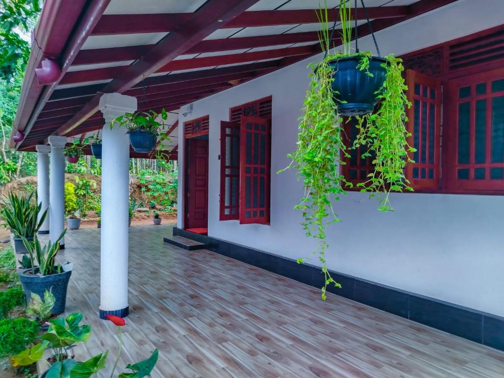 a porch of a house with plants on it at Venuri Villa Midigama in Midigama East