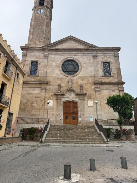 a large building with a clock tower and stairs at Badalona Old Town Dalt de la Vila in Badalona