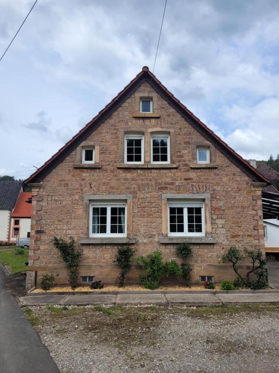 a brick house with three windows on the side of it at Lauberhof in Trippstadt
