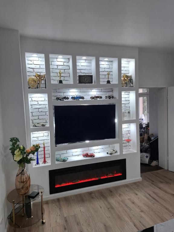 a living room with a flat screen tv on a wall at FeWoZentrum in Lüdenscheid