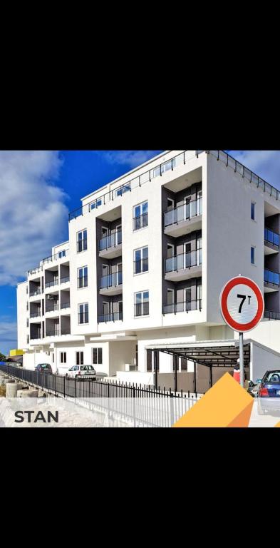 a large white building with a sign in front of it at Azure Coast in Bar