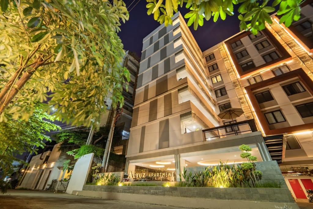 a building in the middle of a city at night at Altuz Apartment Seturan Yogyakarta in Seturan