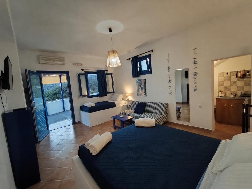 a living room with a large bed and a couch at ENDLESS BLUE Milos in Provatas
