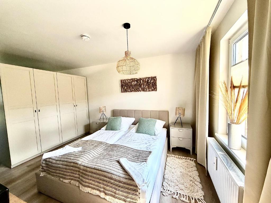 a bedroom with a bed and a pendant light at Bungalow Green Forest in Benz
