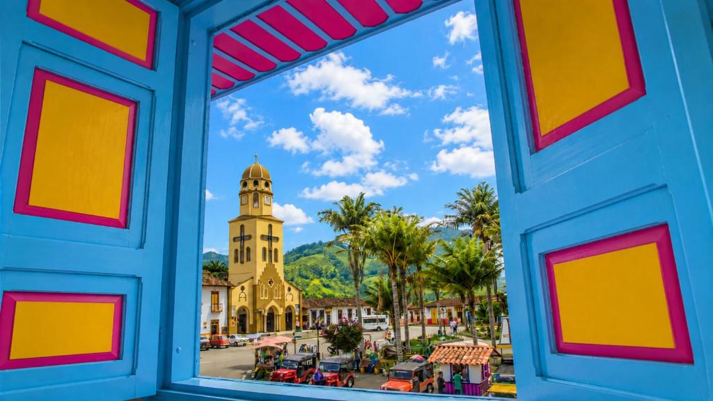 a view of a city from a window at La Posada de la Plaza in Salento