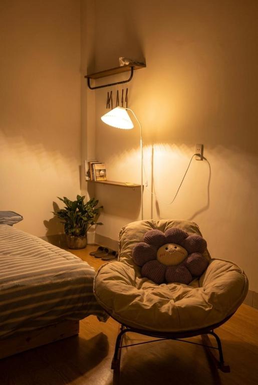 a stuffed teddy bear sitting in a chair in a bedroom at Lấp Ló Home in Danang
