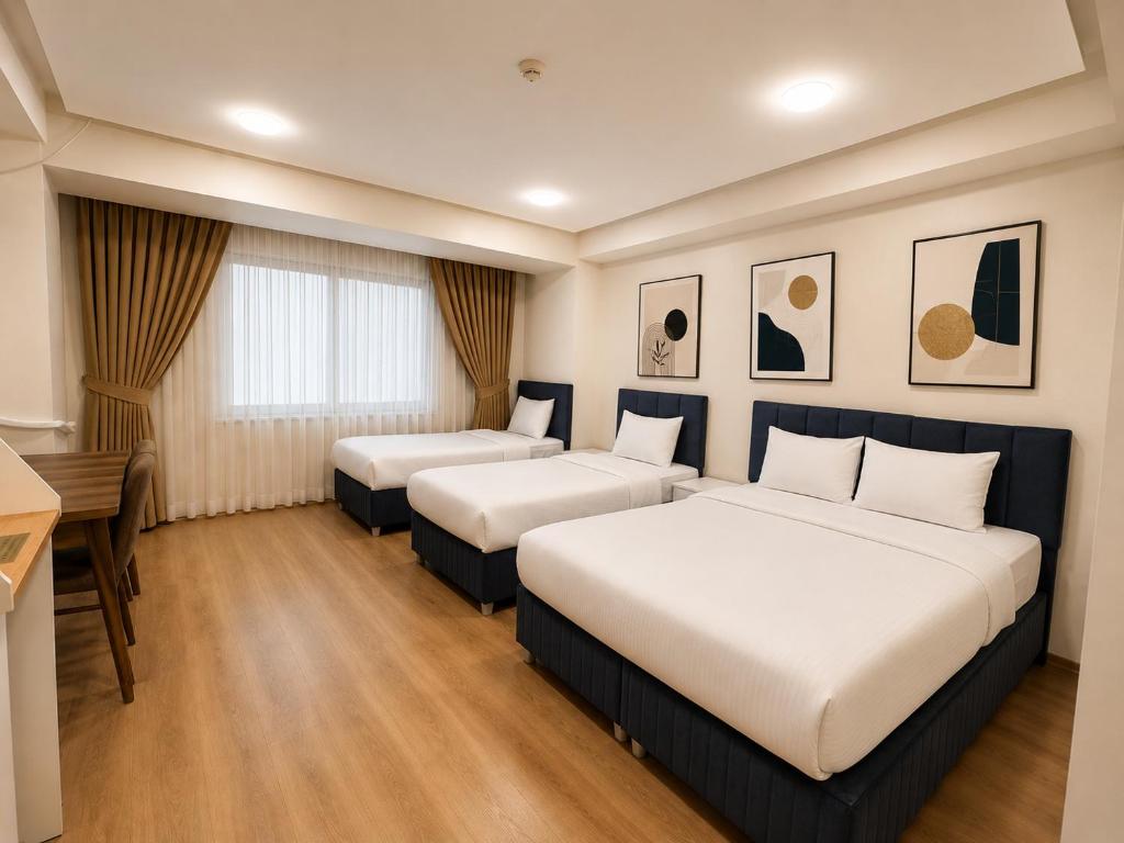 a hotel room with two beds and a desk at Stay Istanbul Hotel in Istanbul