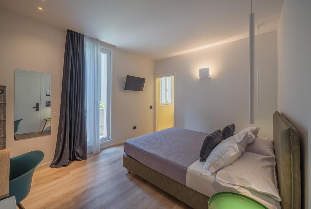 a bedroom with a bed and a large window at Dimora in Prato in Padova