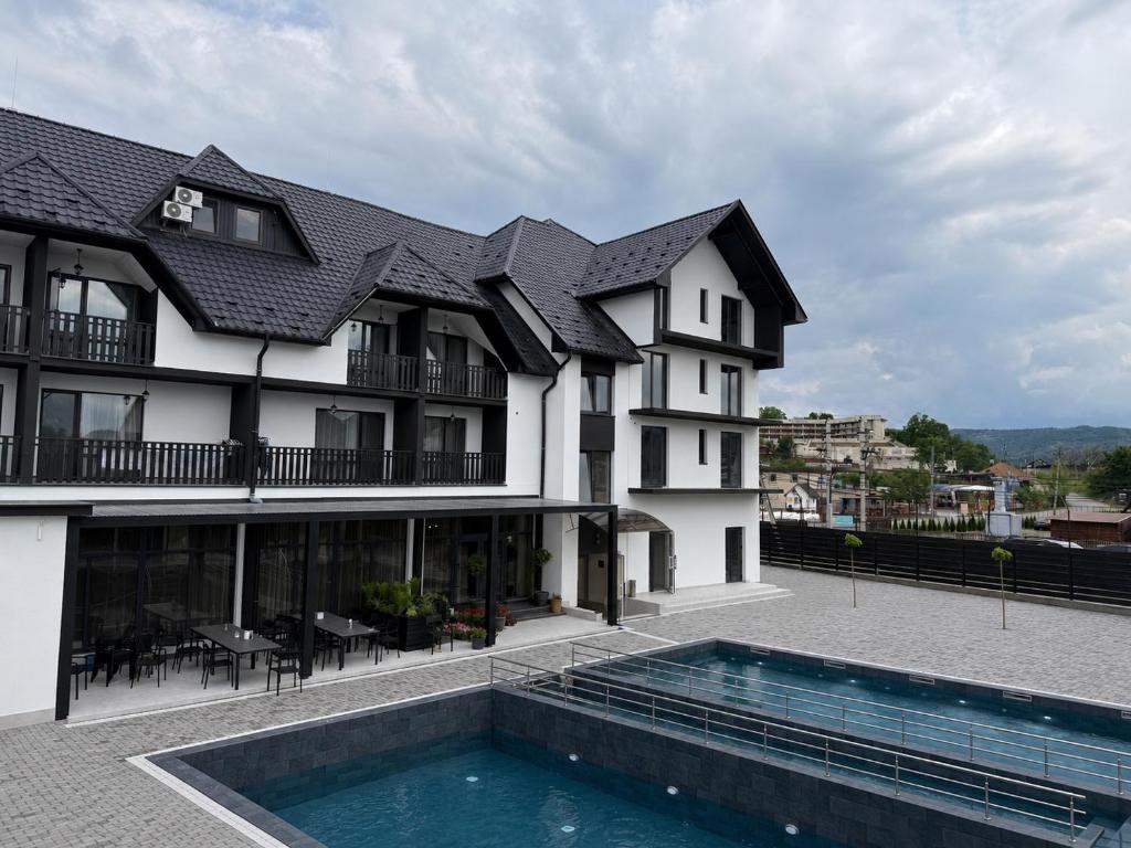 a building with a swimming pool in front of it at Edelweiss New 2026 Солотвино in Solotvyno
