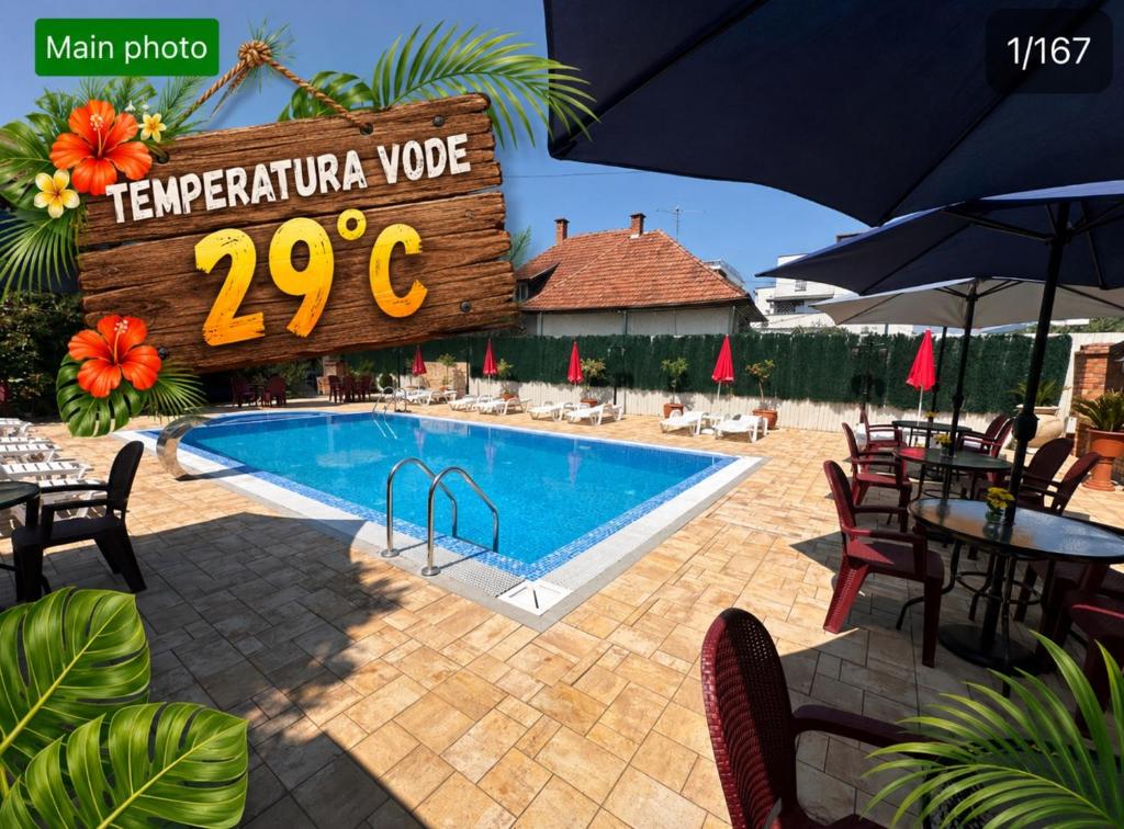 a swimming pool with a sign that reads terrapinariavoice at Smeštaj TEA sa dva bazena i besplatan parking in Vrnjačka Banja