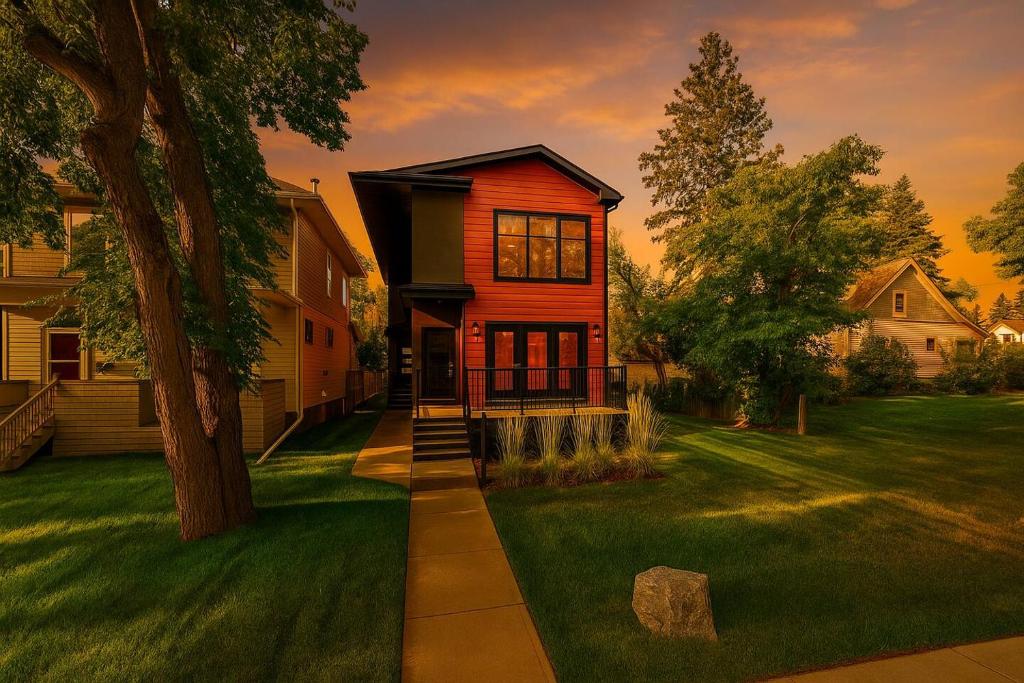 a house with a tree in a yard at Chic Hideaway - King Bed - Fireplace - Garage - AC - DT and WEM in Edmonton