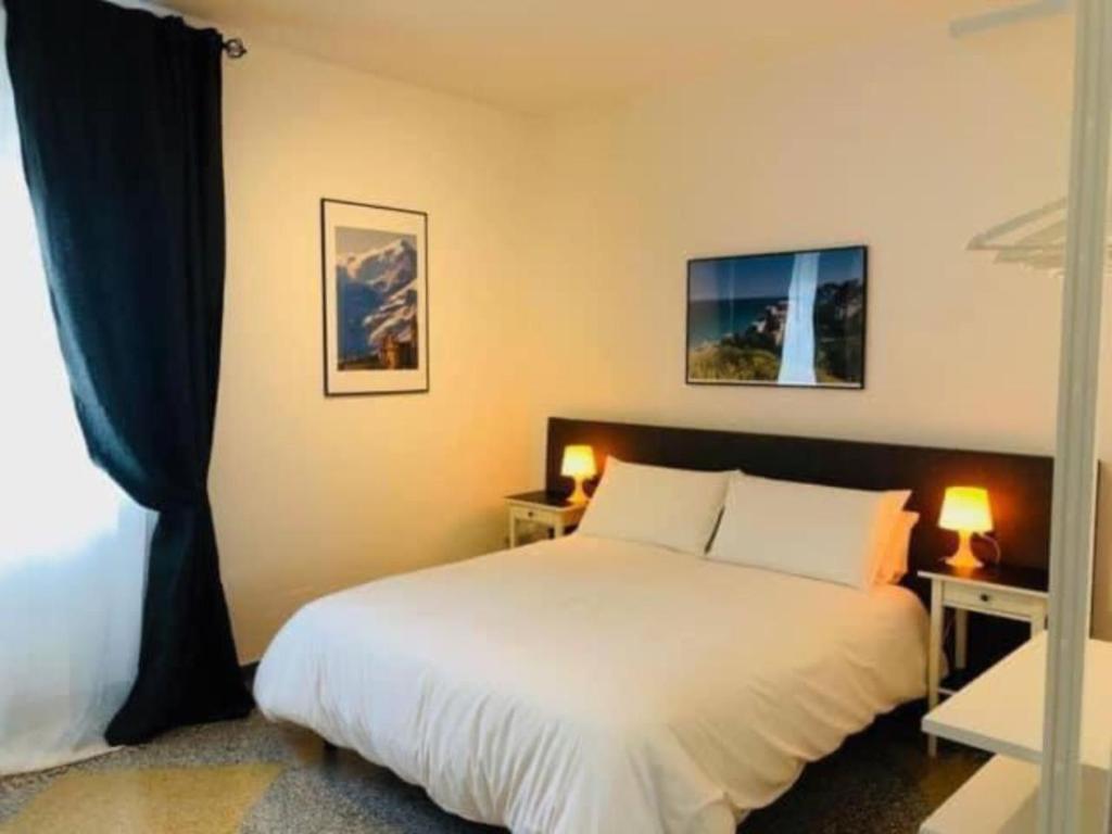 a bedroom with a white bed and two lamps at LoLè Apartment - Ancona in Ancona