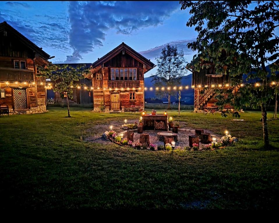 a fire pit in front of a log cabin at night at SCHENE Kammer in Abtenau
