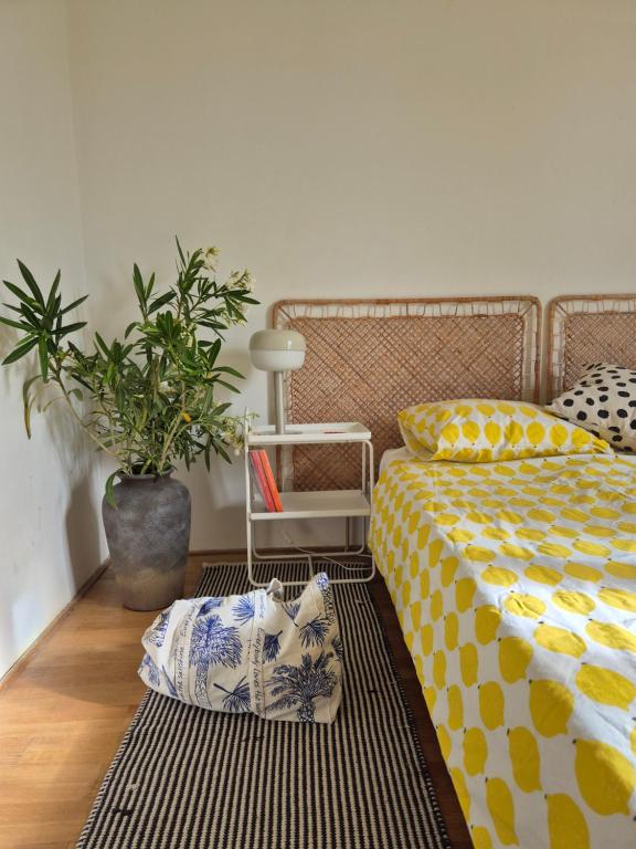 a bedroom with a bed and a potted plant at Otto Novalja, spacious penthouse apartment in city center in Novalja