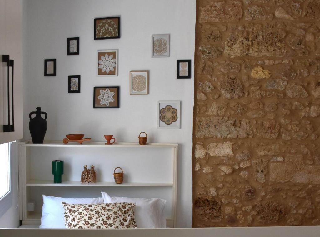 a living room with a stone wall and a couch at Stone Suites in Famagusta