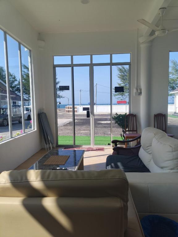 a living room with a couch and a table at Aimers Lodge in Dungun