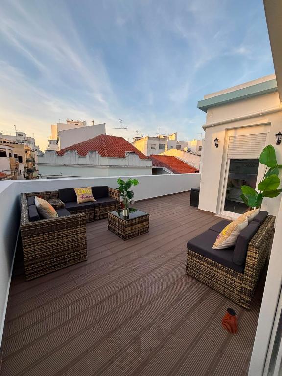 a balcony with couches and a fireplace on a roof at Blessed House in Portimão