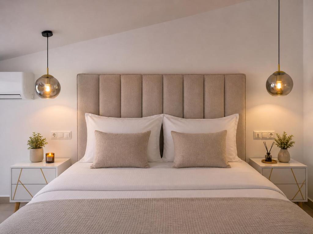 a bedroom with a large white bed with two night stands at Mini Boutique Dragani in Sykia Chalkidikis
