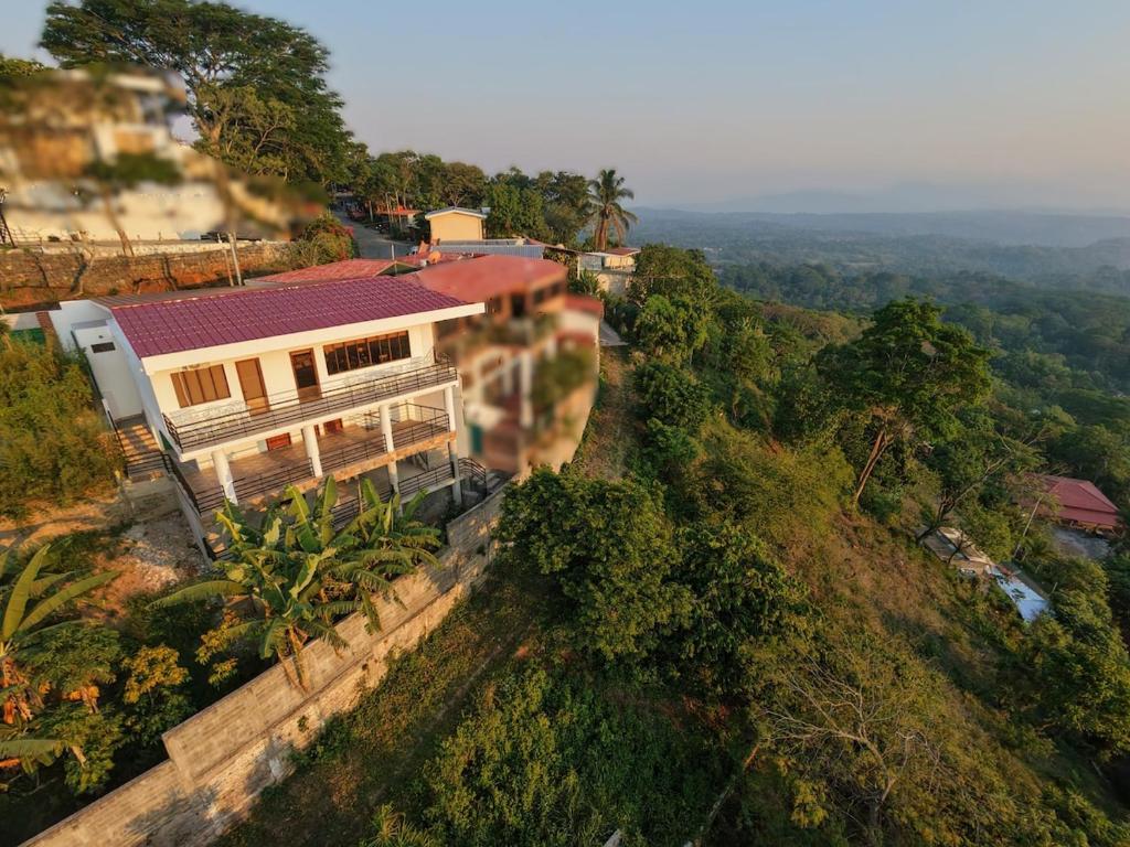 a house on top of a hill with trees at Altura & lago in San Nicolás