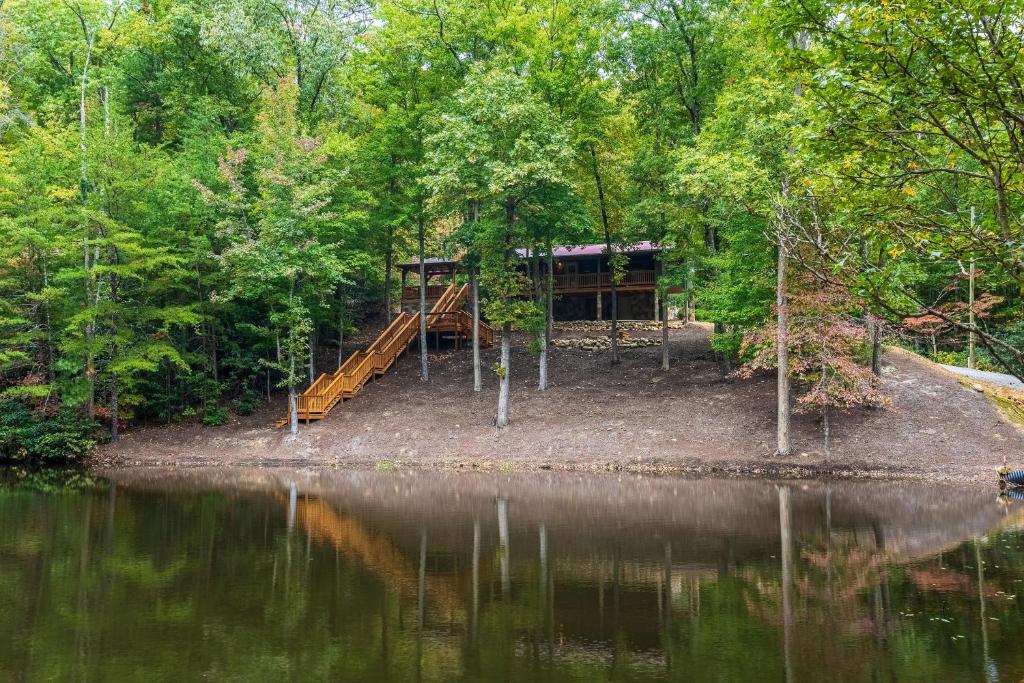 a cabin in the woods next to a lake at Beside Still Water 2 in Cosby