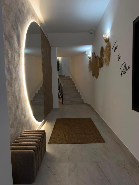 a hallway with a staircase with a couch and a mirror at Alojamientos LUMARA in Peal de Becerro