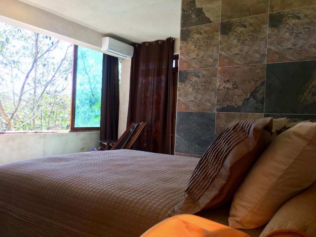 Postel nebo postele na pokoji v ubytování Hotel Casa Maya Calakmul
