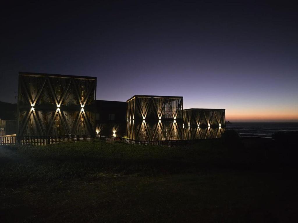 a building on top of a hill at night at Qbos Matanzas in Matanzas