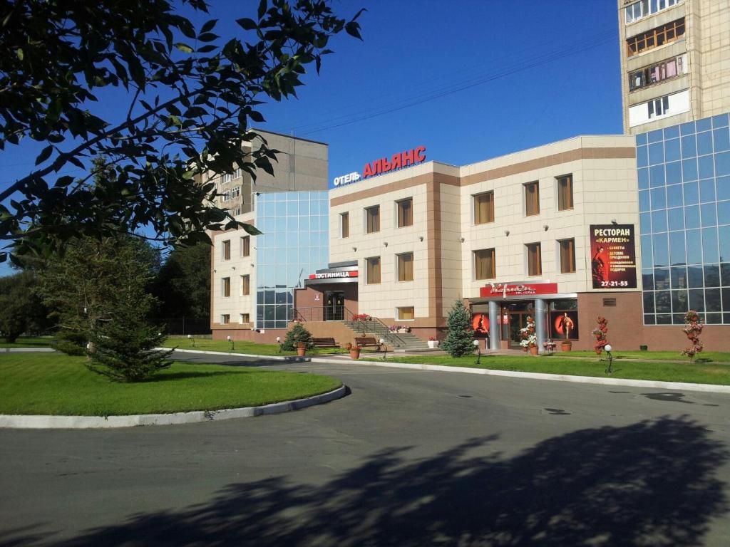 an empty street in front of a building at Hotel Aliance in Orsk