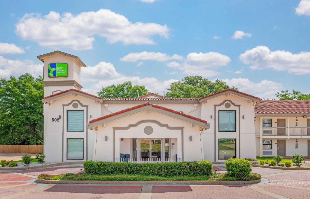 a building with a clock tower on top of it at Extended Stay America Select Suites - Longview in Longview