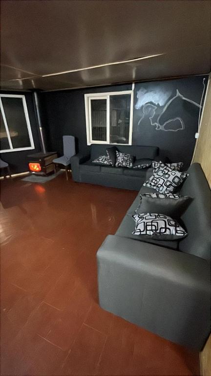 a large living room with a couch at Habitación Hostal Refugio Gaucho in Cochrane