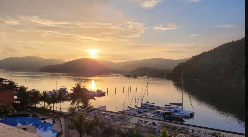 a view of a harbor with boats in the water at Condominio Baleares,Marina Porto Itacuruca in Mangaratiba